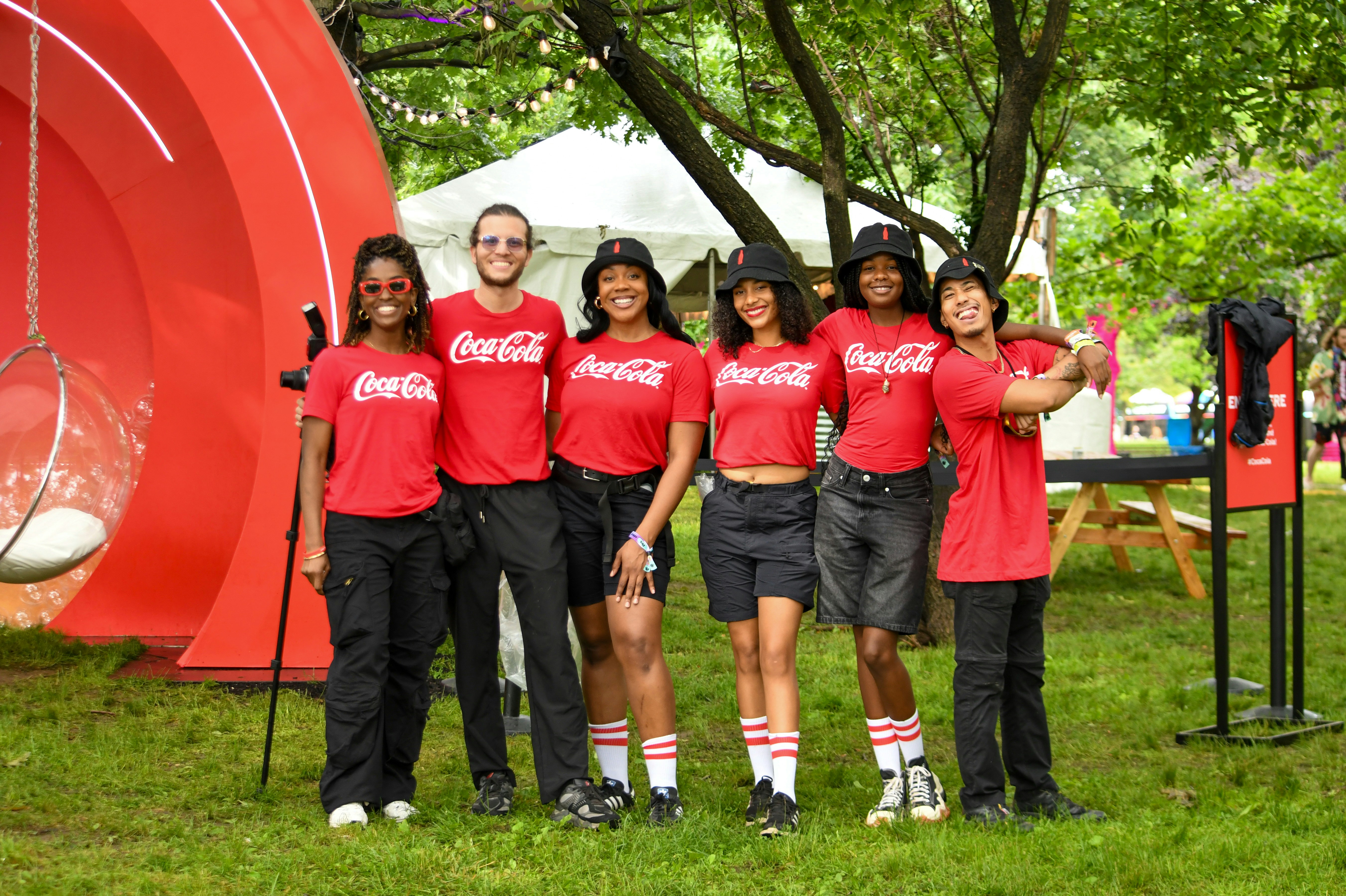 Coca-cola employees posing for a group photo.
