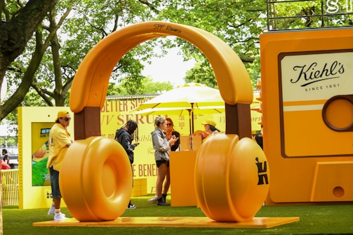 Giant headphones stand next to a cassette display.