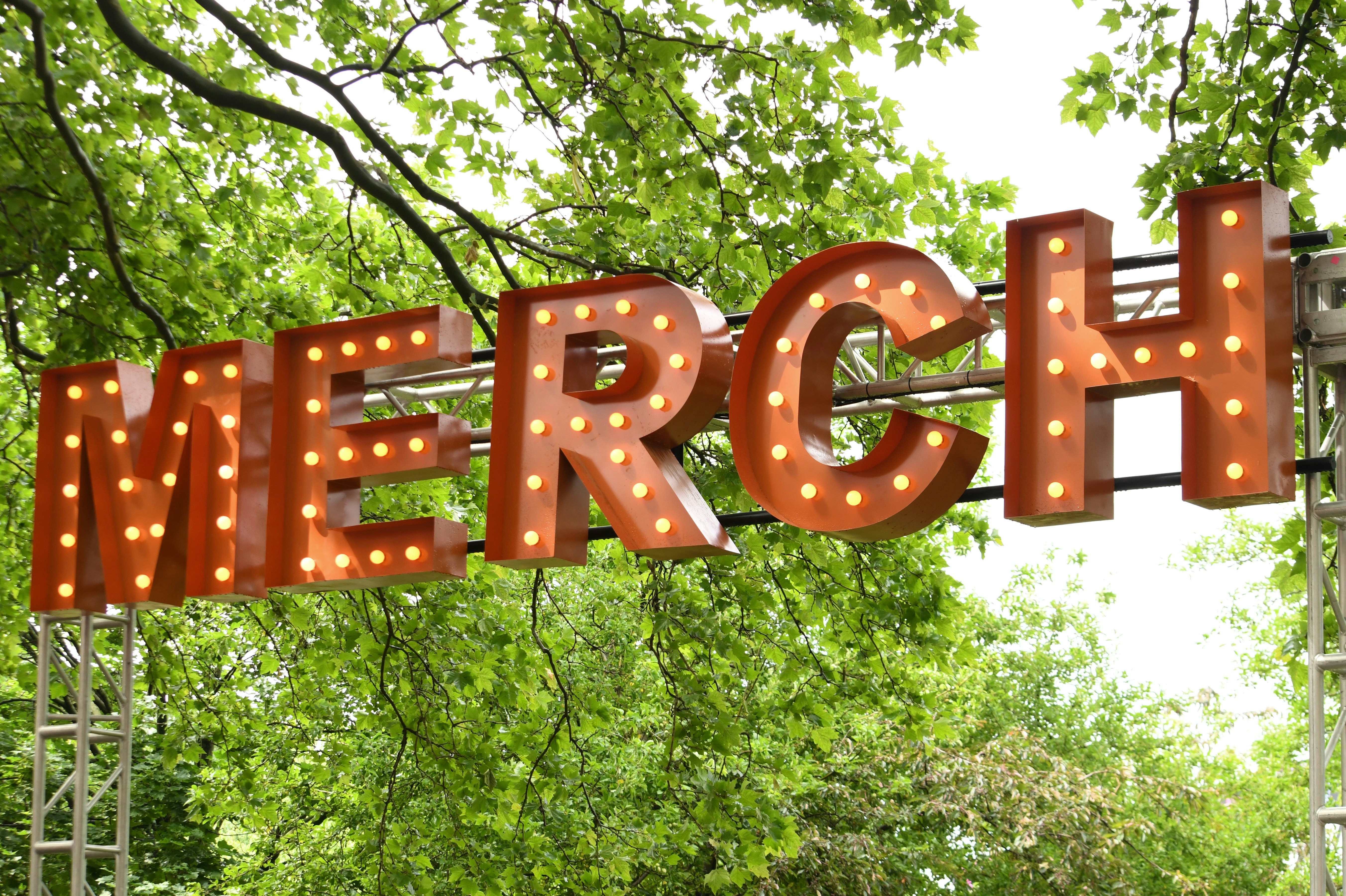 The image shows a lit-up merch sign.