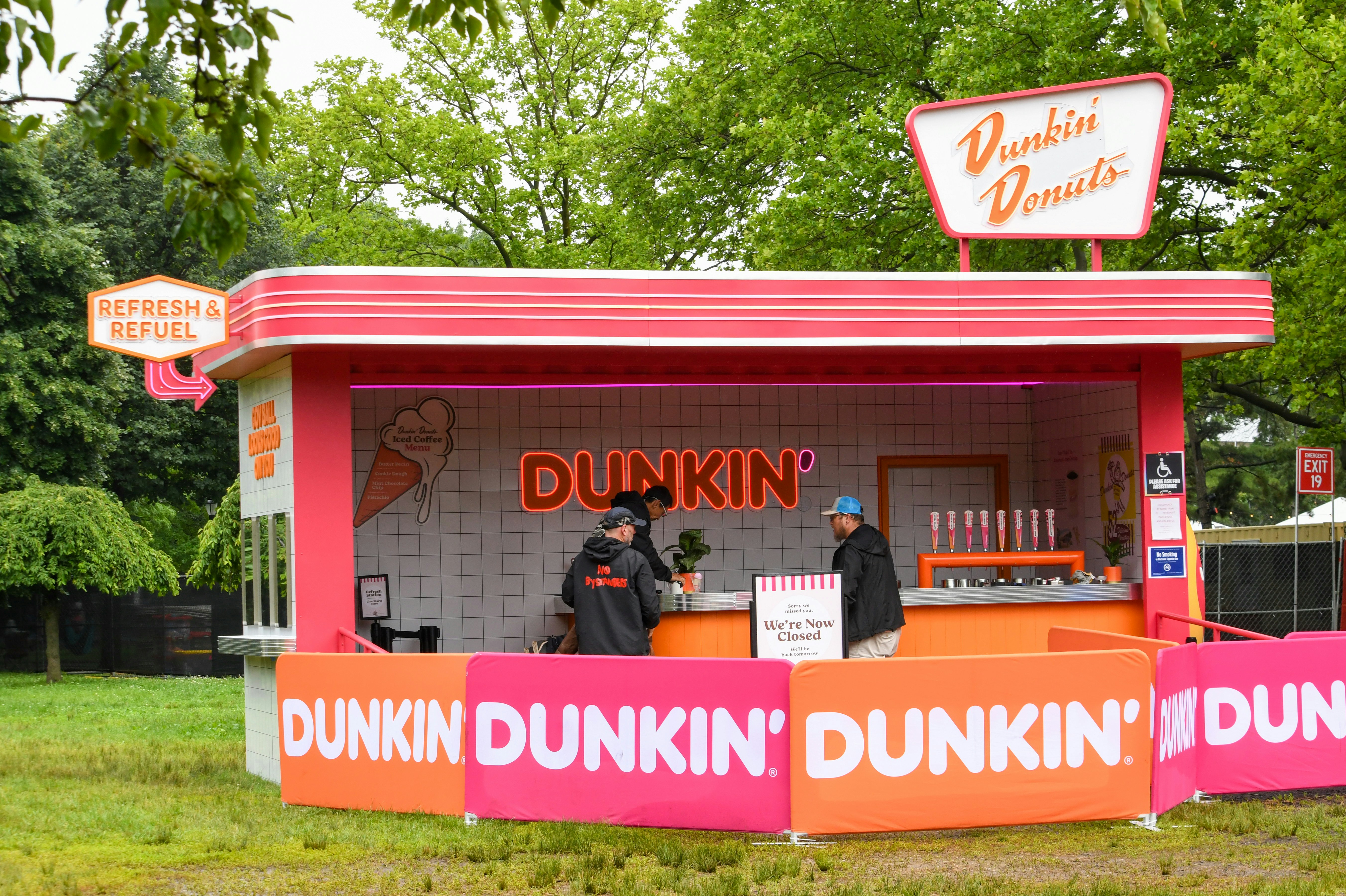 Dunkin' donuts sells treats at an outdoor booth.