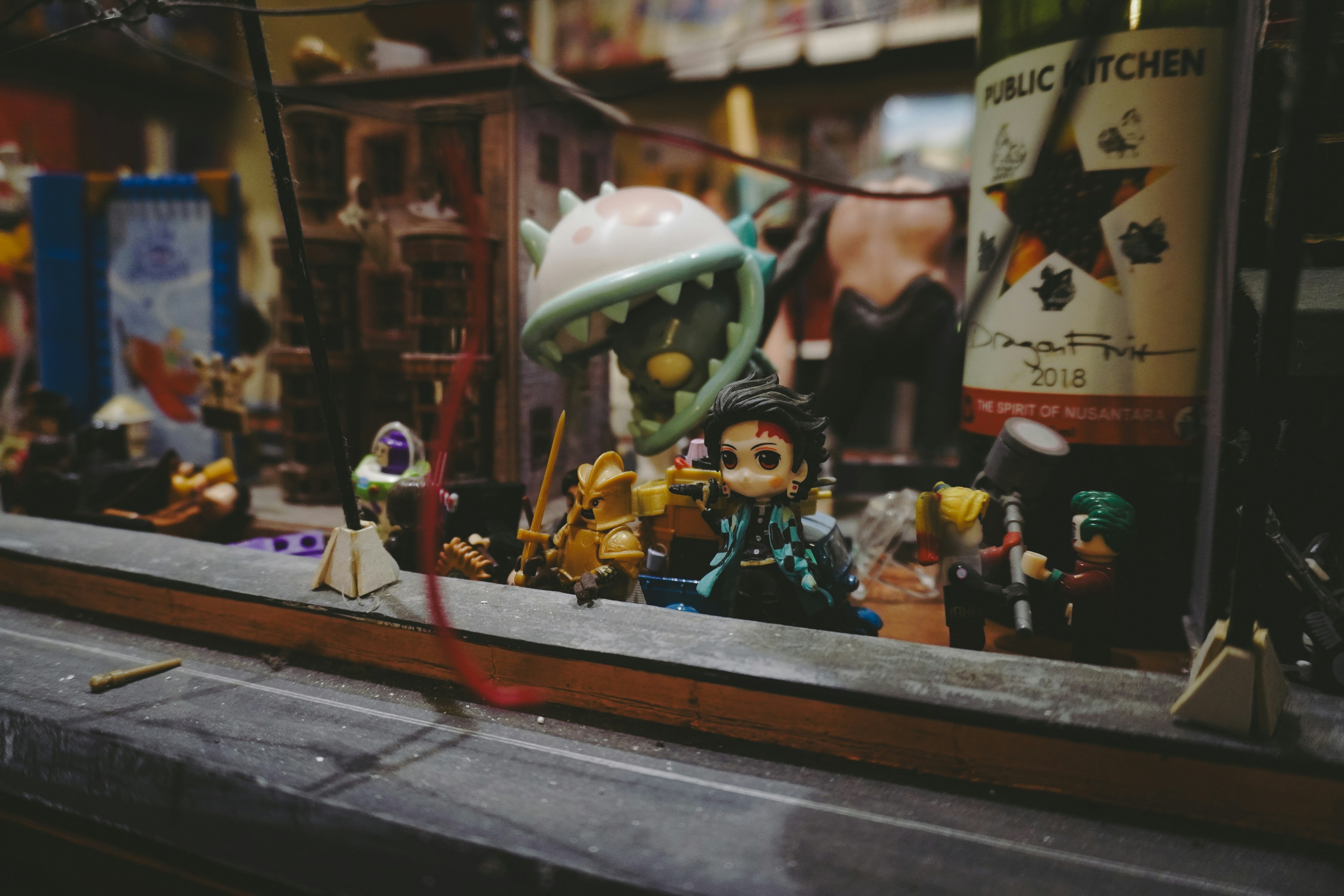 Many tiny figurines displayed in a window.