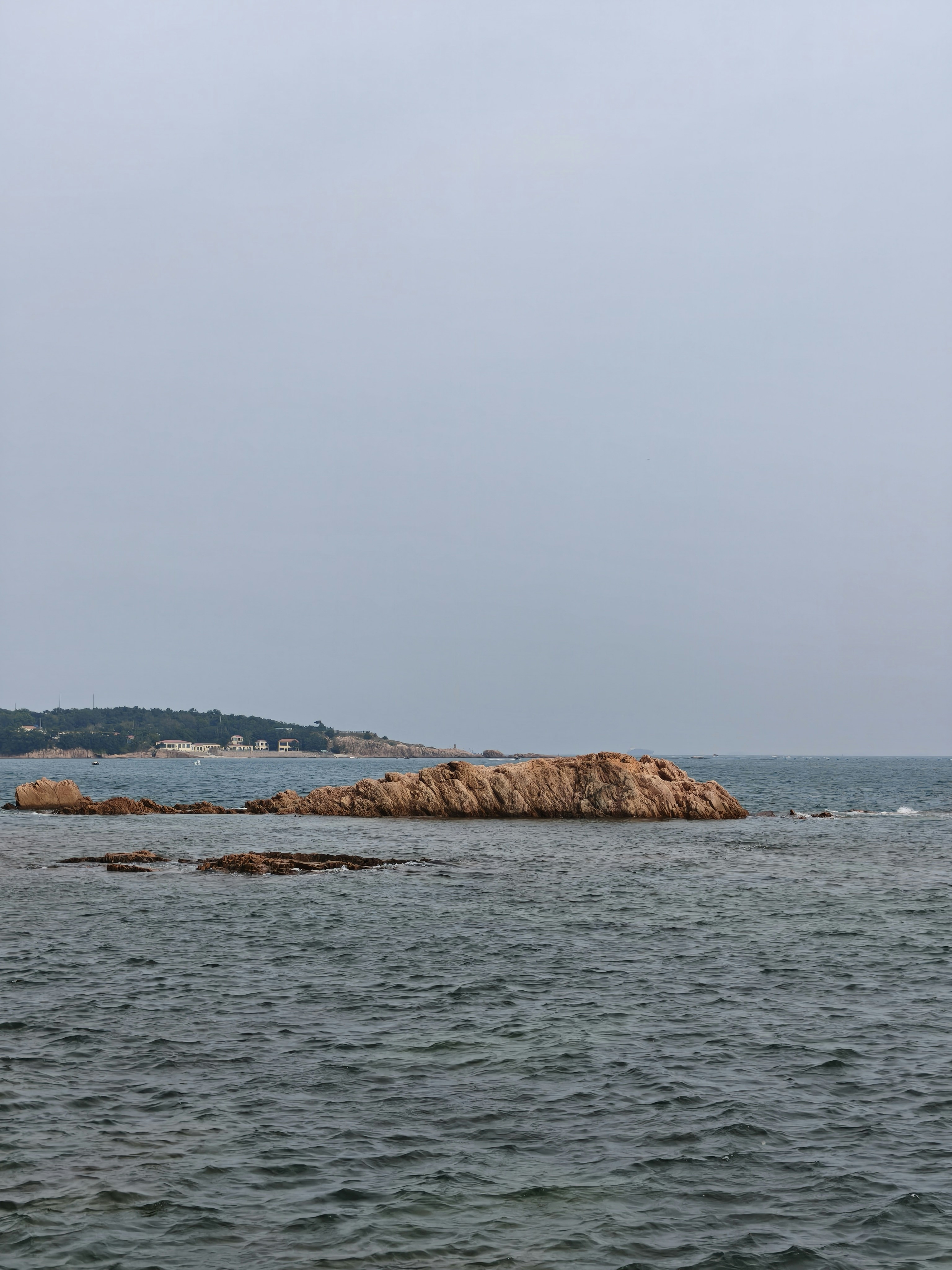 Rocky islands rise from a serene ocean.