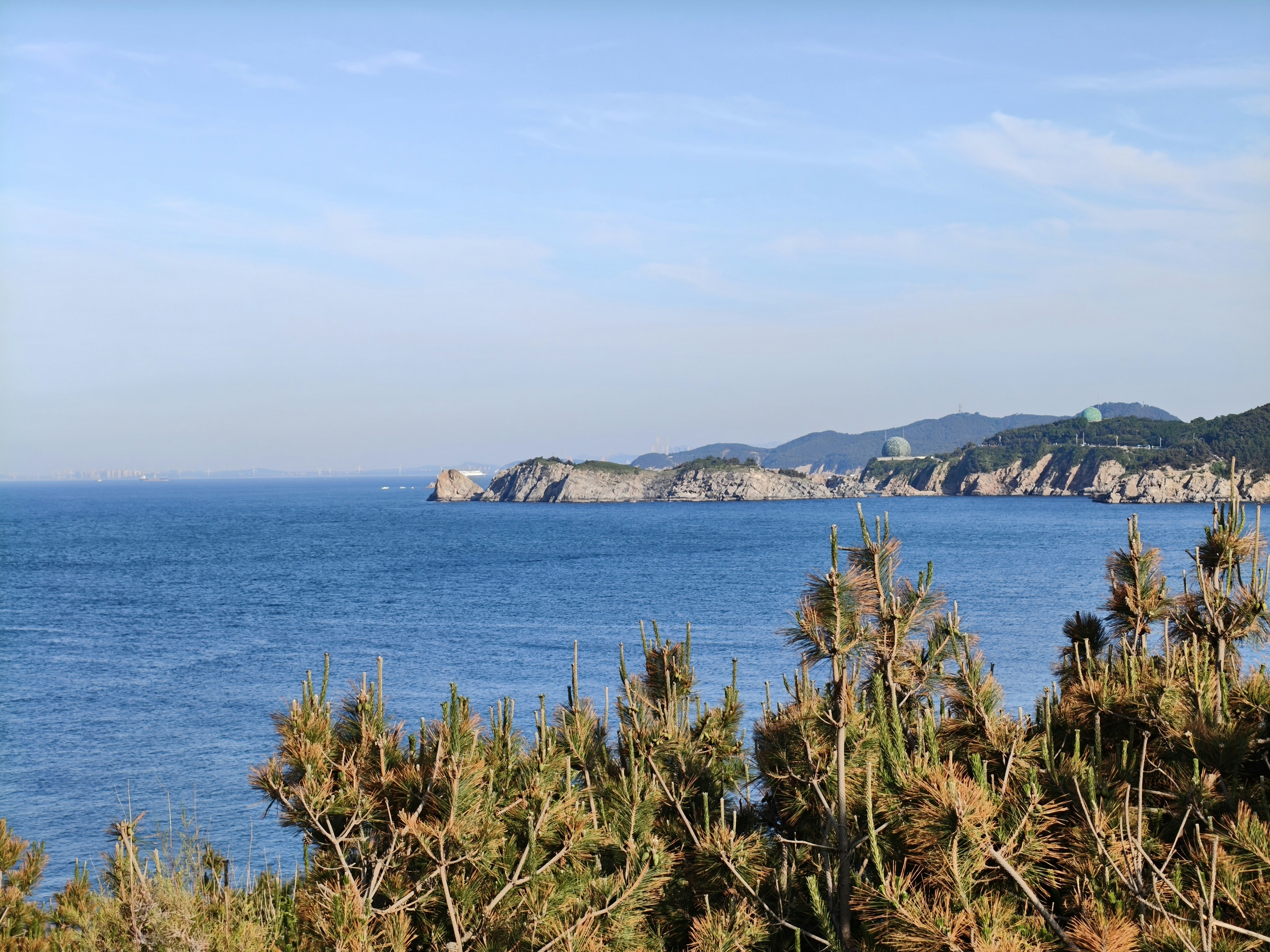 Ocean views and rocky coast under a clear sky.