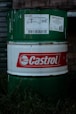 A castrol oil drum sits in the grass.