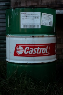 A castrol oil drum sits in the grass.