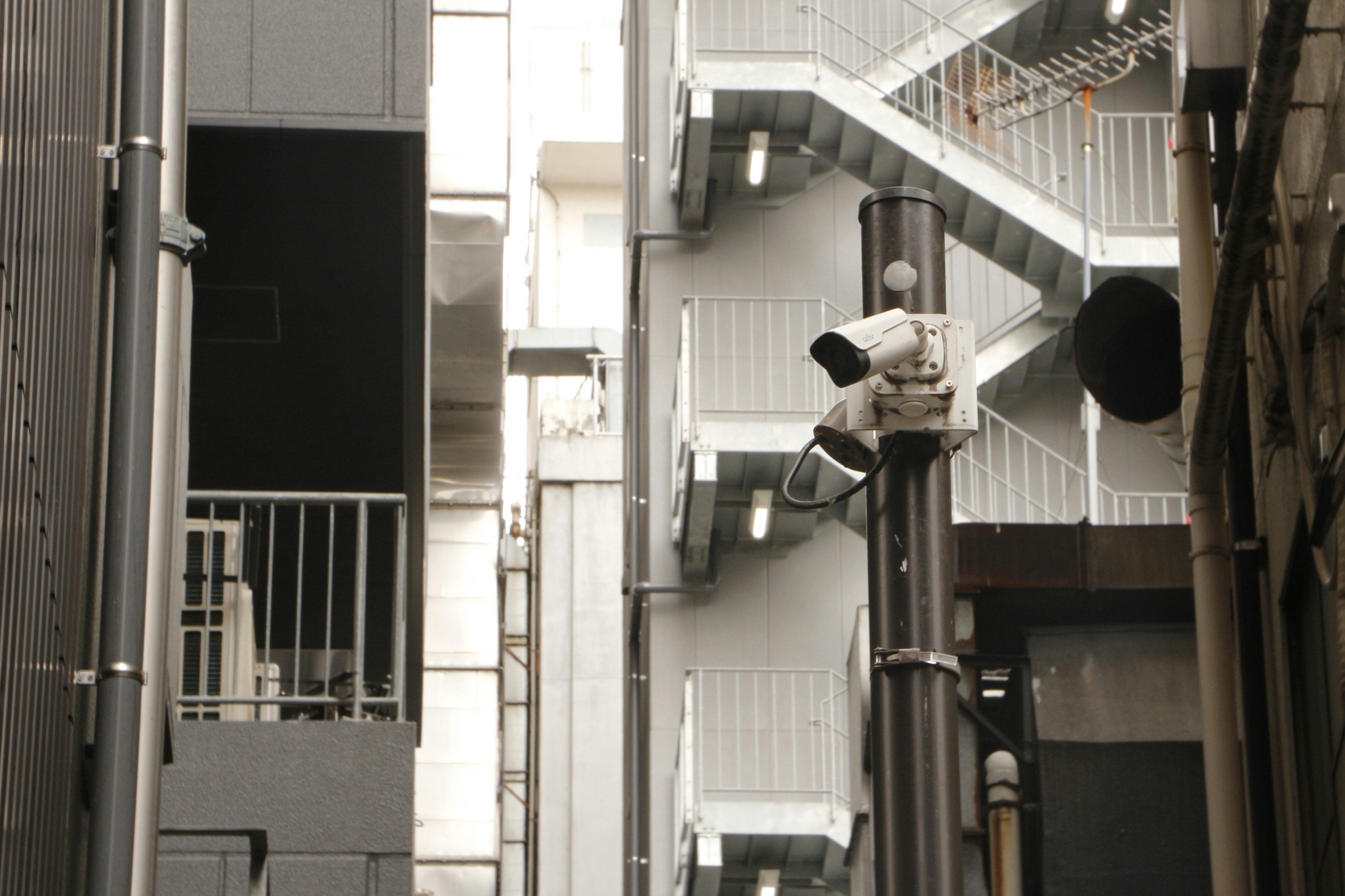Buildings and a pole with a traffic light.
