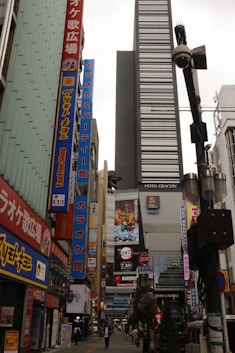 A narrow city street in japan, with many buildings.