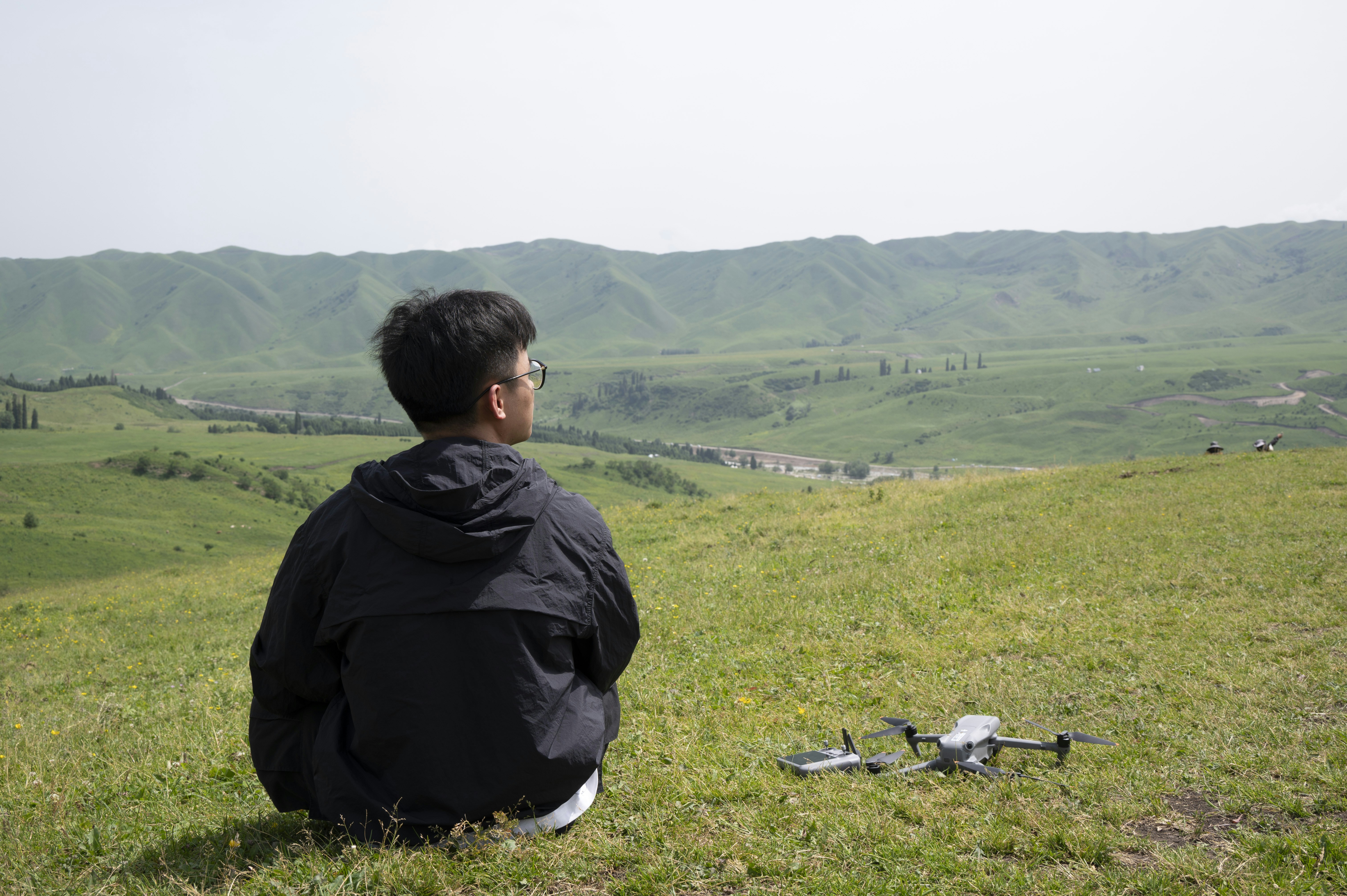 Japanese farmer looking at drone