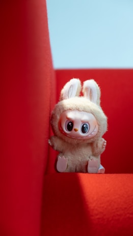A plush bunny toy sits inside a red space.