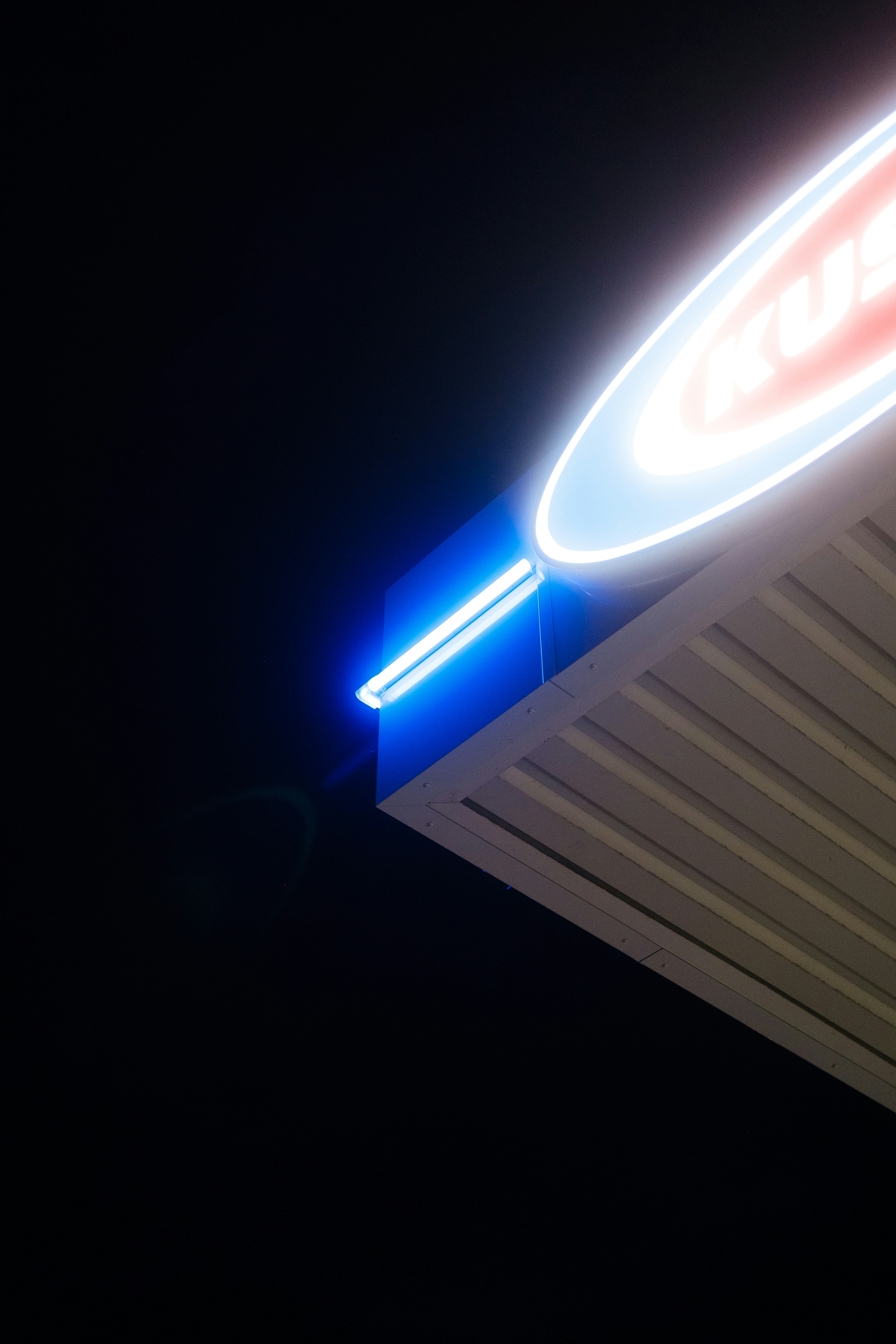 Neon sign illuminates the dark night sky