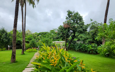 A green garden path leads to the distance.