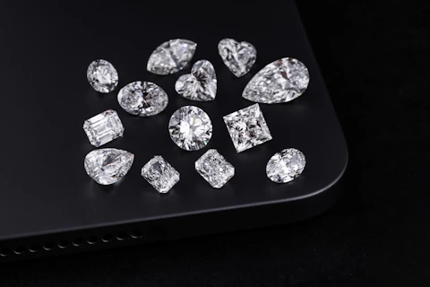 Diamonds of various shapes are on a black surface.
