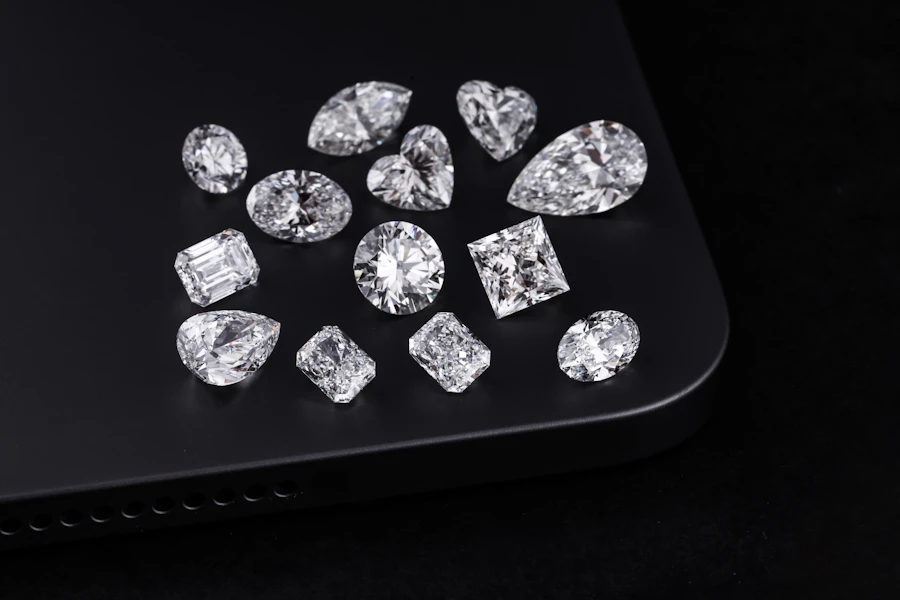 Loose diamonds in different shapes on a black surface