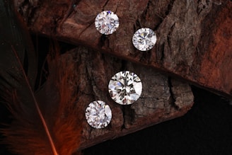 Diamonds shine on a rustic wooden surface.