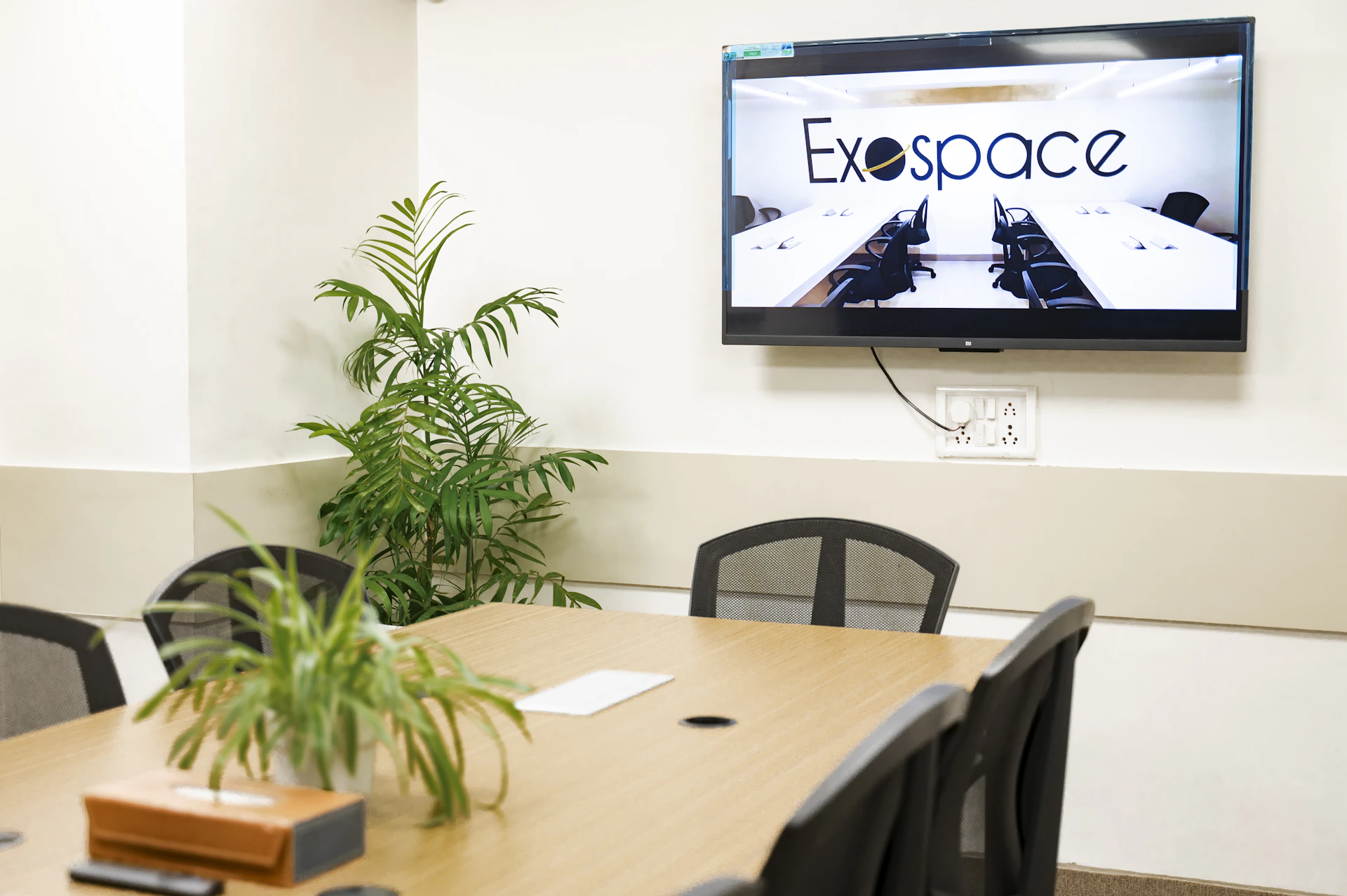 A meeting room with exospace logo displayed.