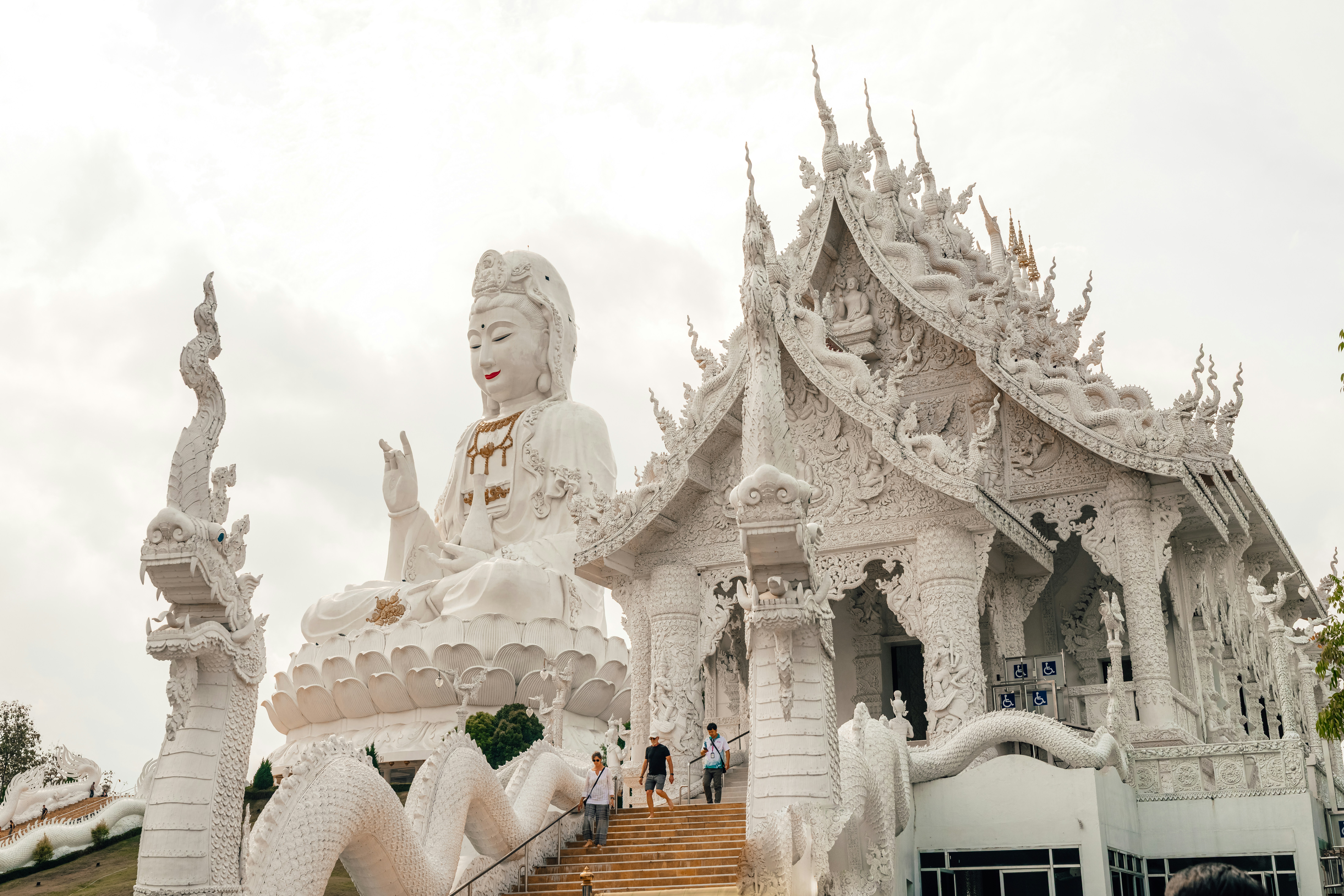 A majestic, white temple with a statue. - Sukhothai