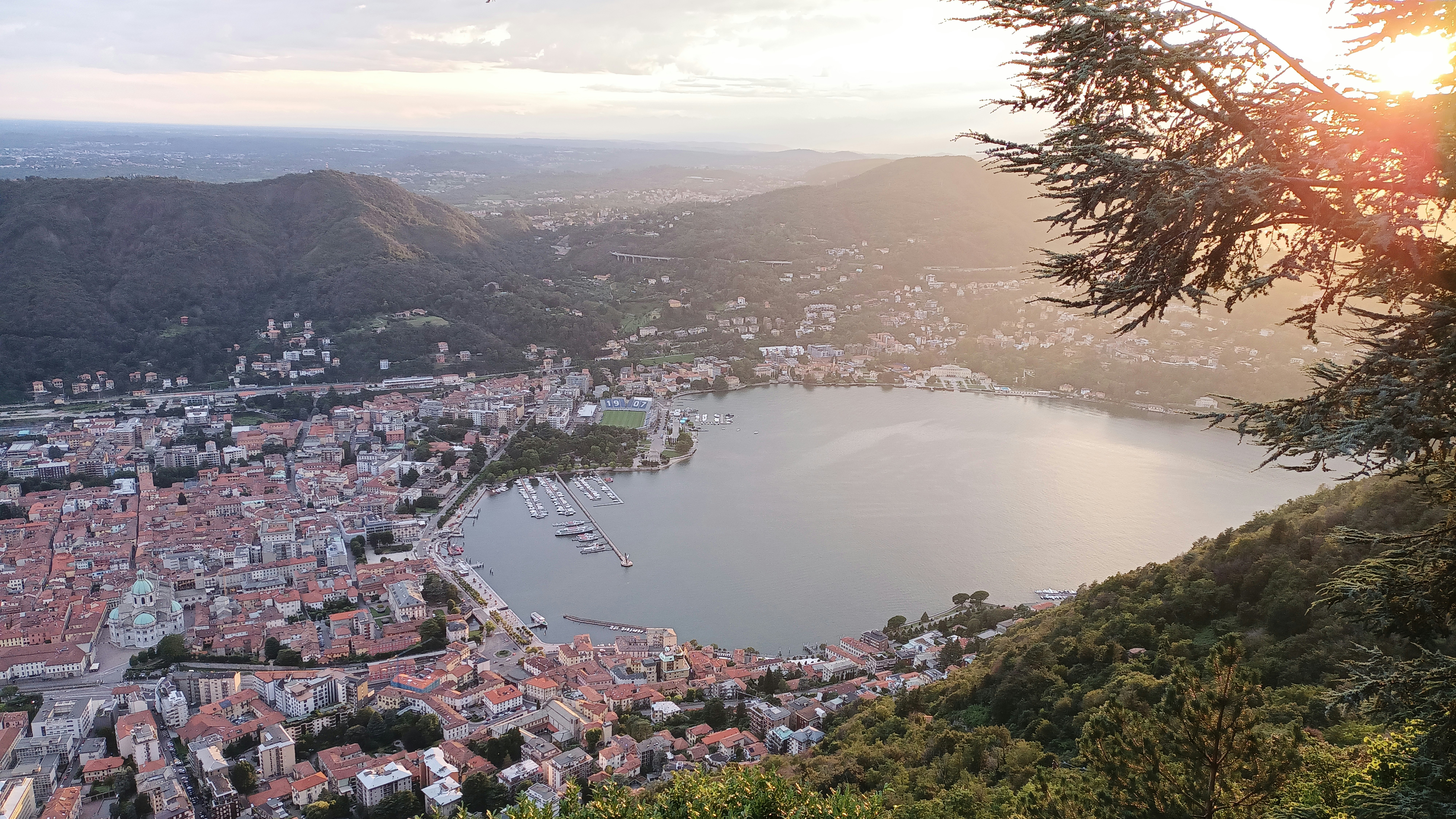 A scenic view of a lake and city.