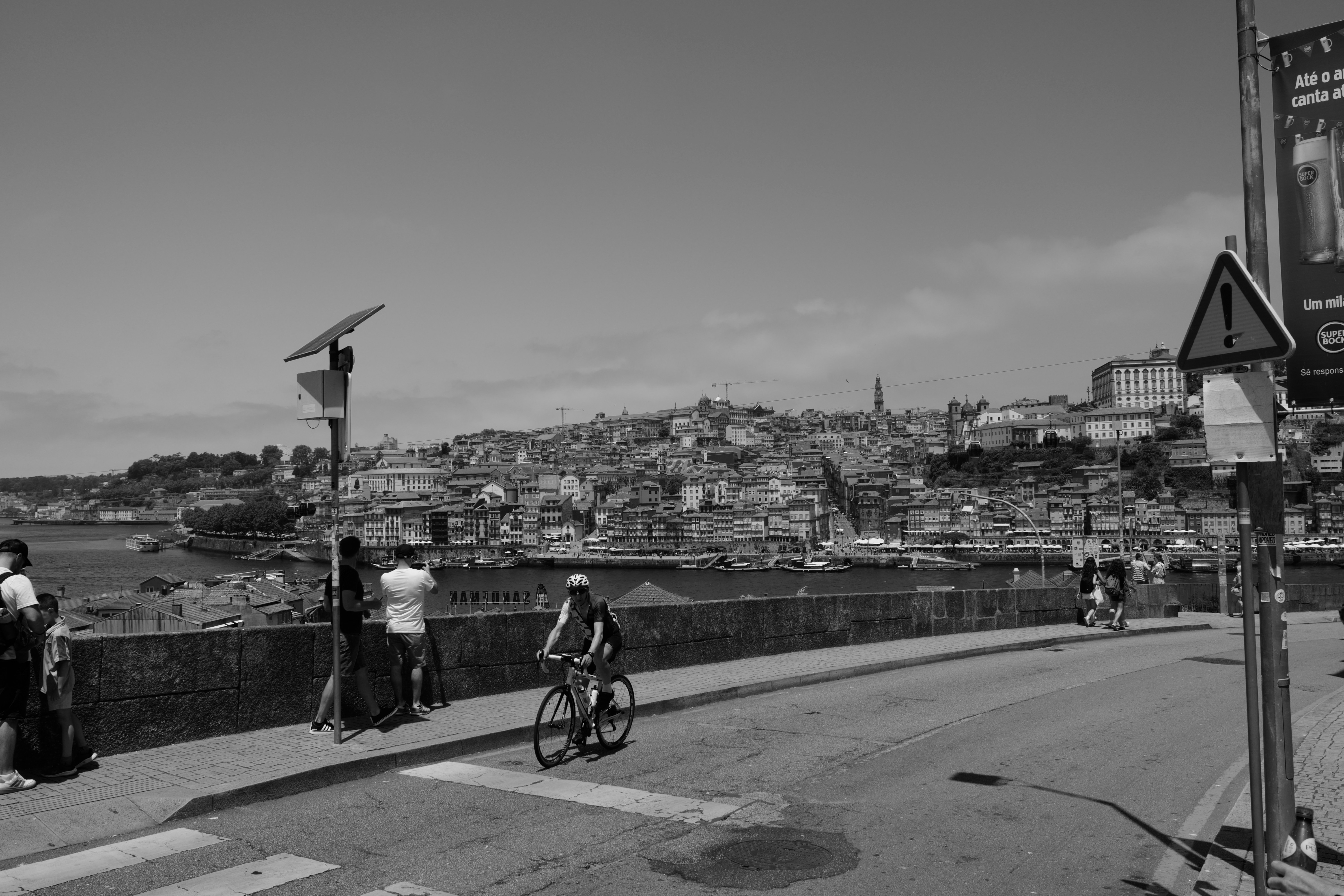 A person looking out over a valley, their adventure bike parked nearby.
