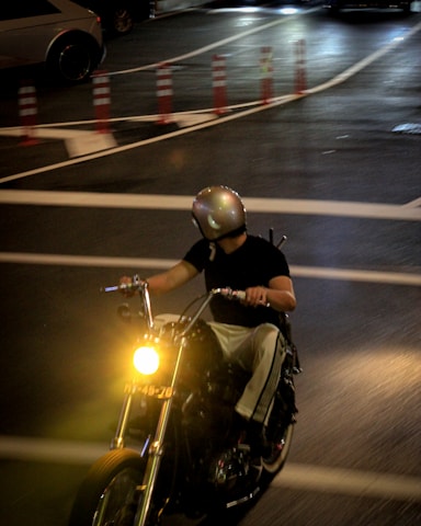 A motorcyclist rides at night.