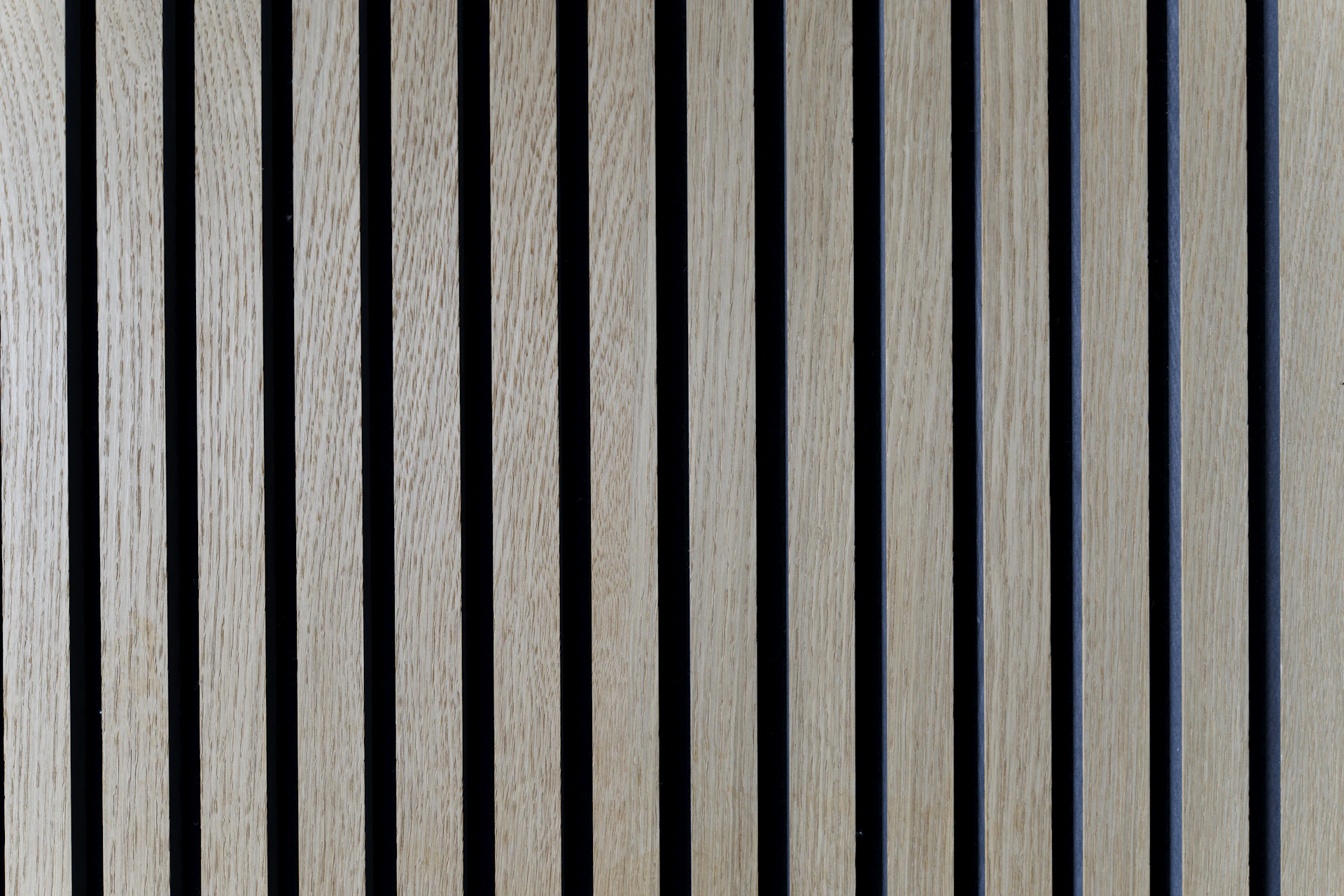 Wooden planks arranged vertically create a textural pattern.