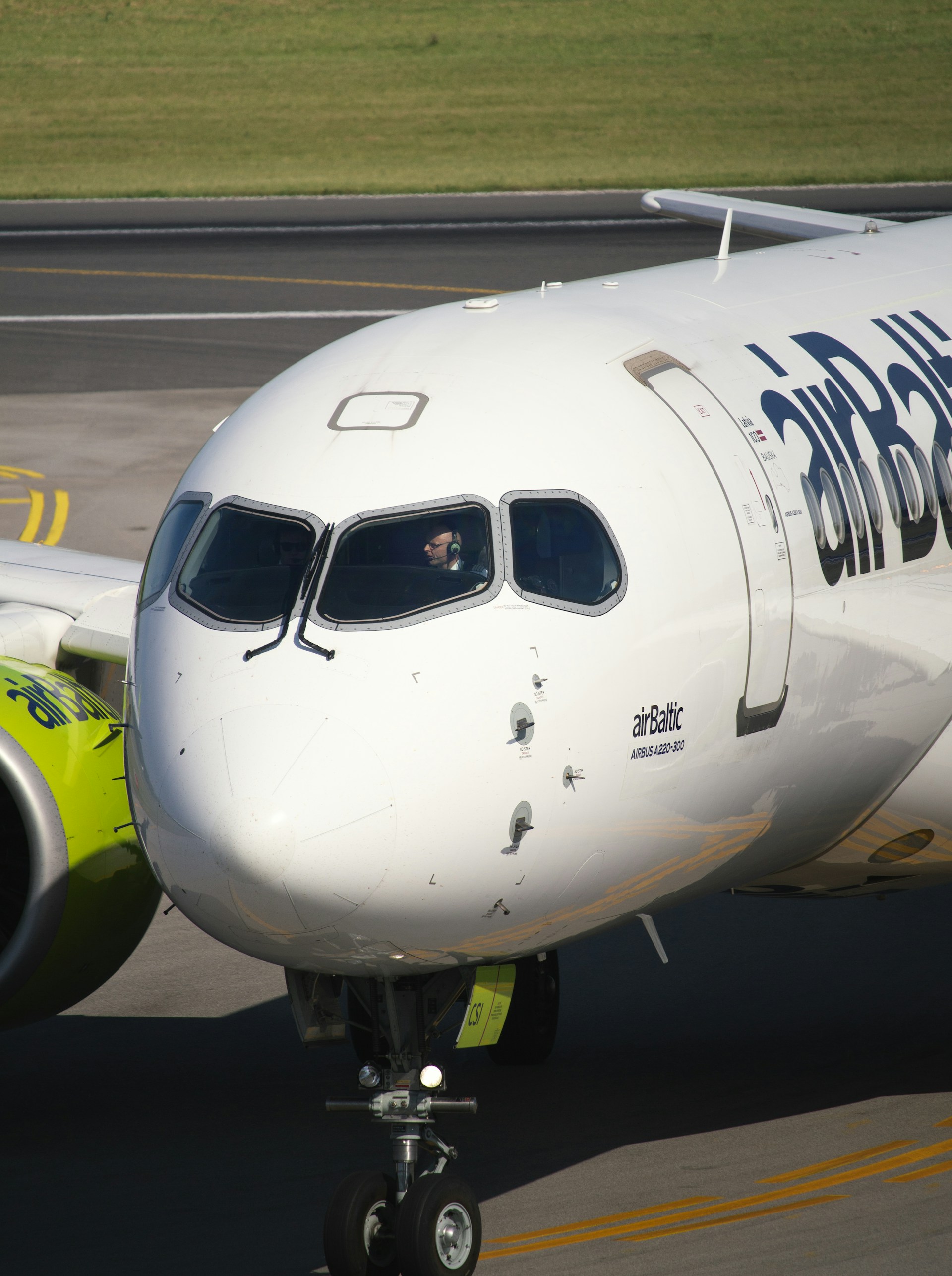 An air baltic airplane sits on the runway.