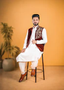 A man wears traditional pakistani attire.