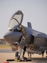 Mechanic works on the fighter jet before takeoff.