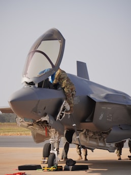 Mechanic works on the fighter jet before takeoff.