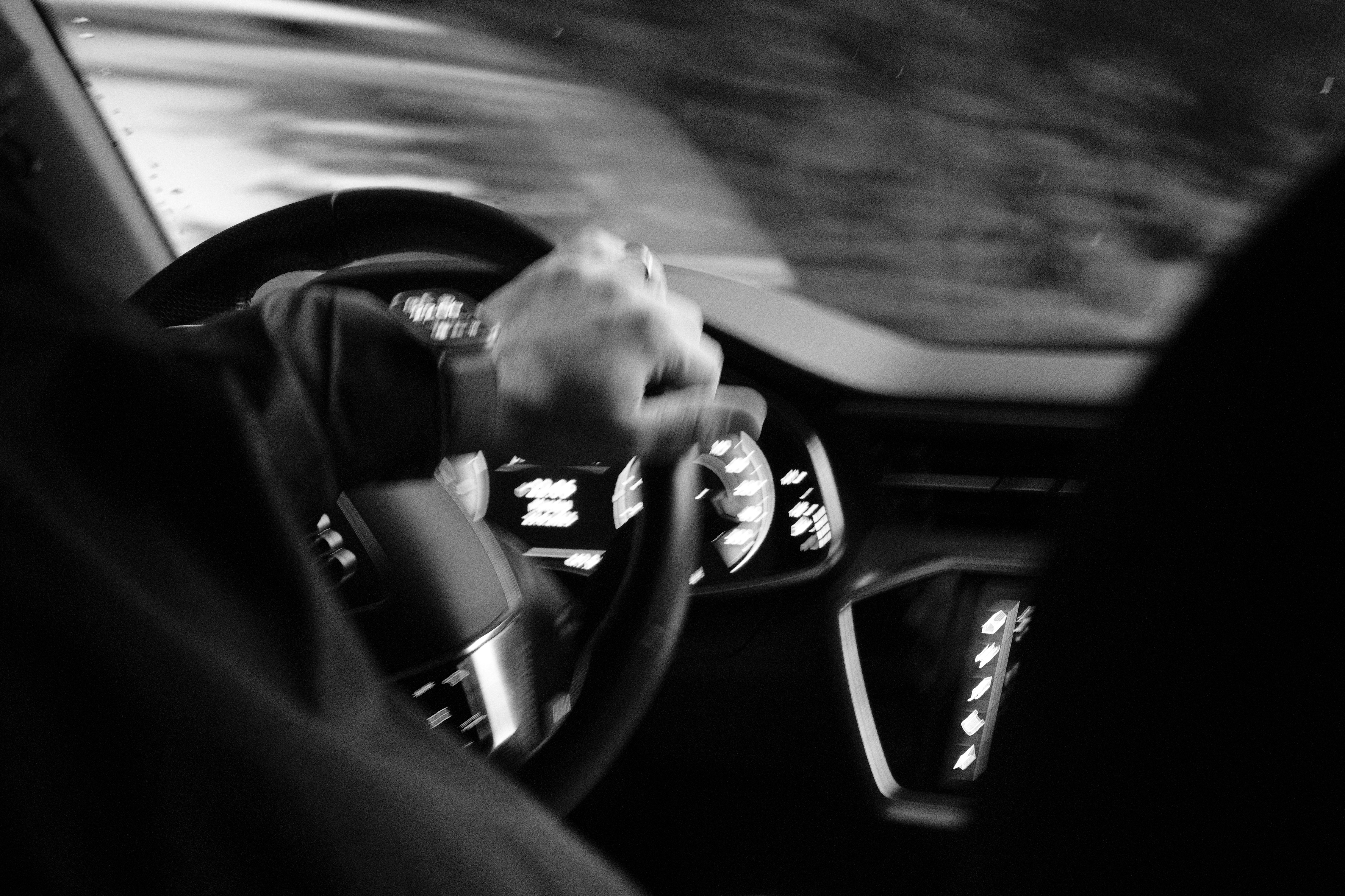 Someone drives a car at night.