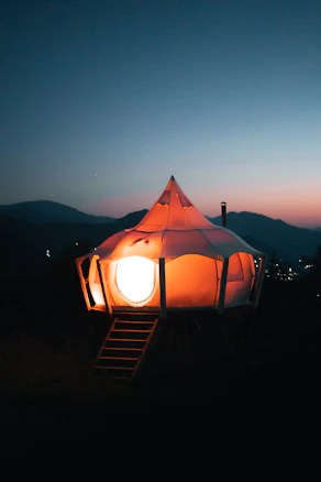 Glowing tent illuminated at night.