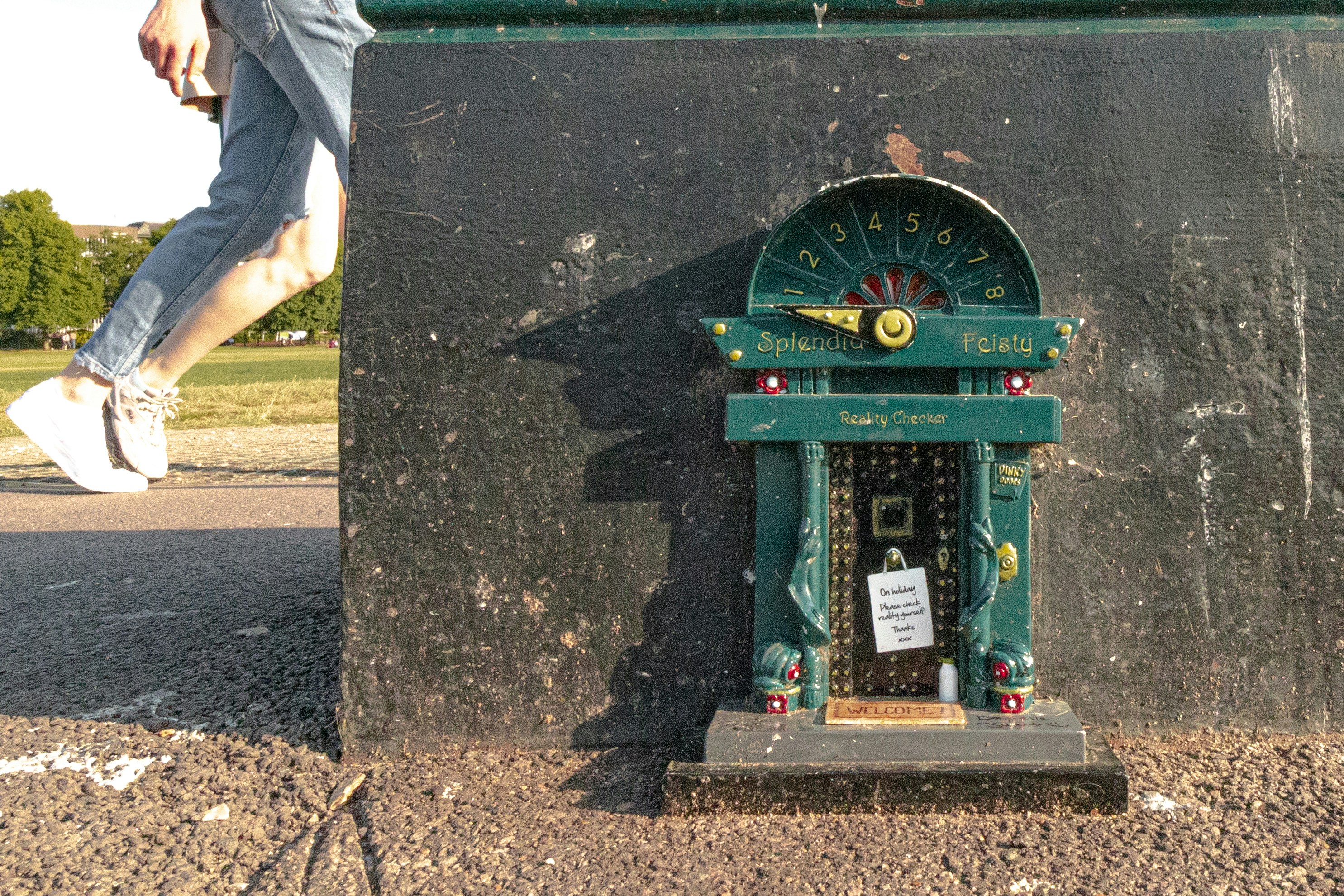 Miniature door and person walking by.