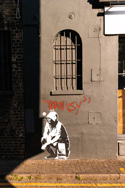 Banksy artwork features on an exterior wall.