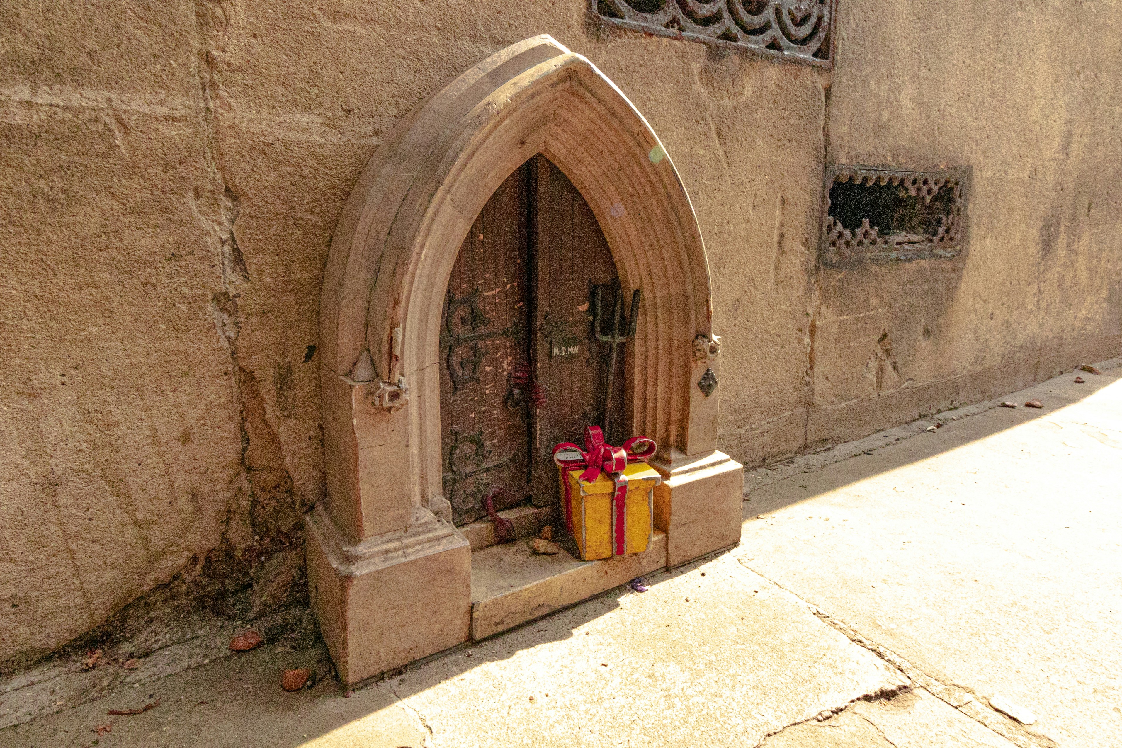 A tiny door has gifts left outside.