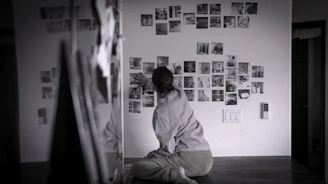 A person looks at photos on the wall