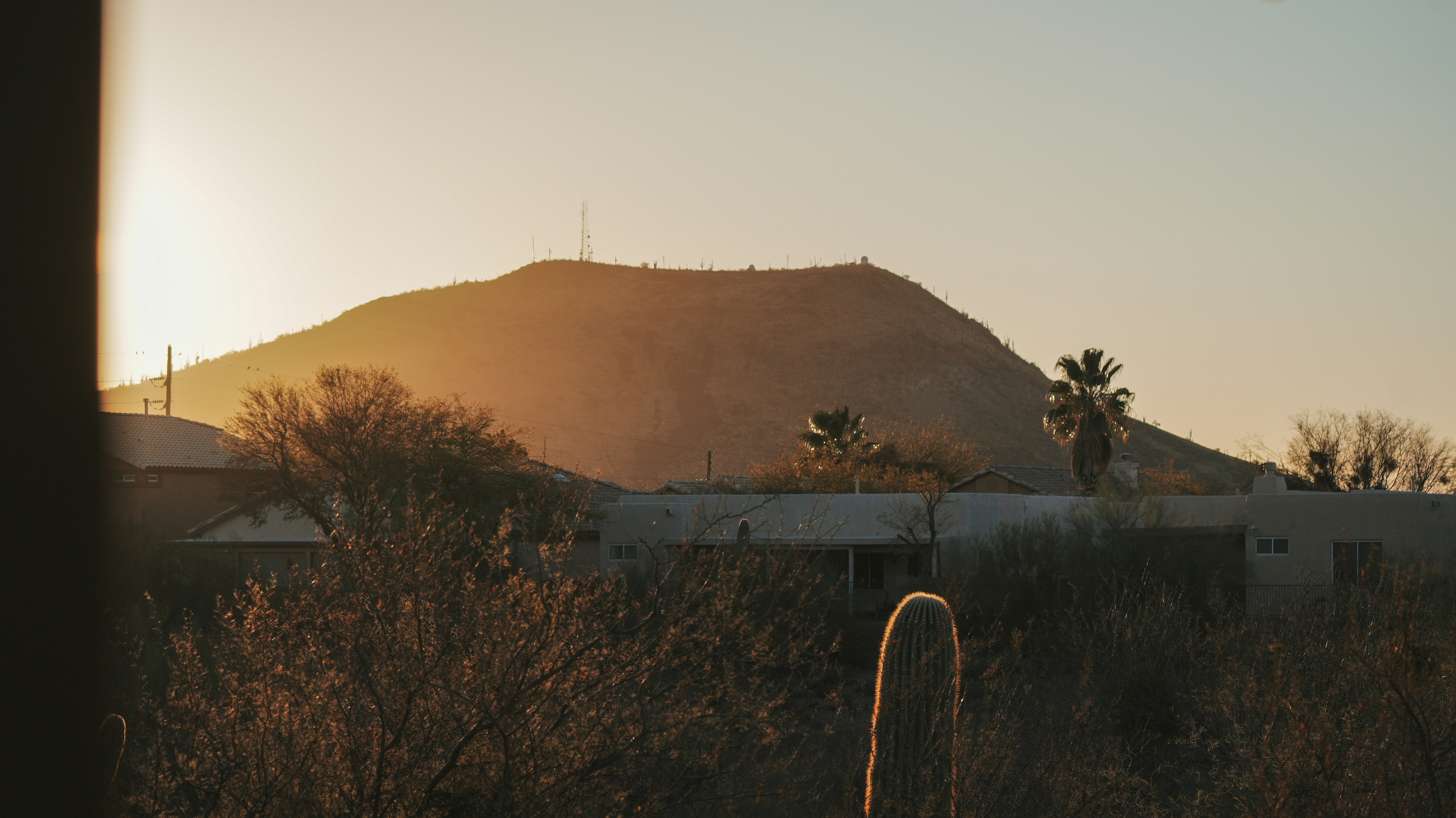 Mountain silhouettes against a warm sunset.