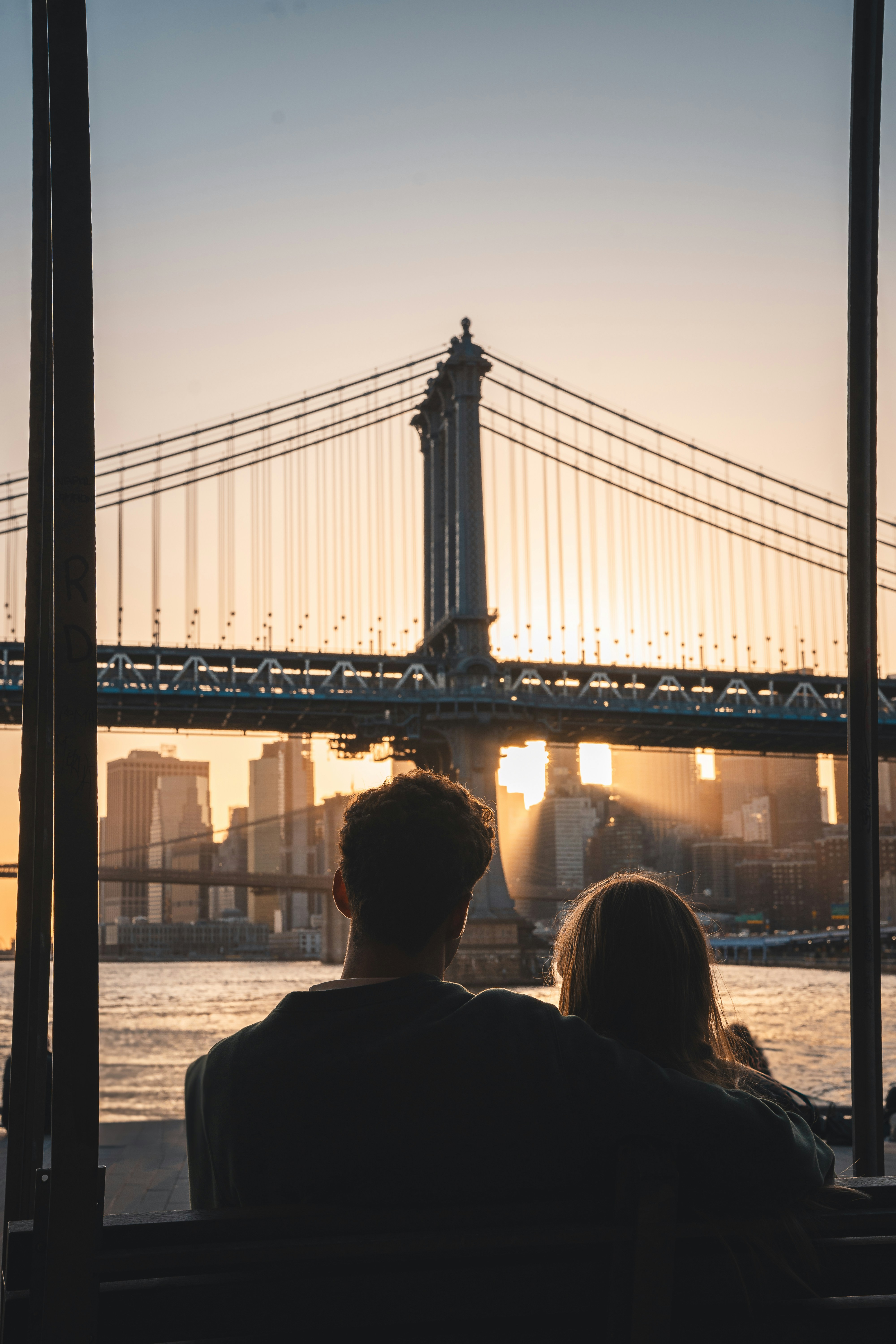 Couple watches sunset over the manhattan bridge
