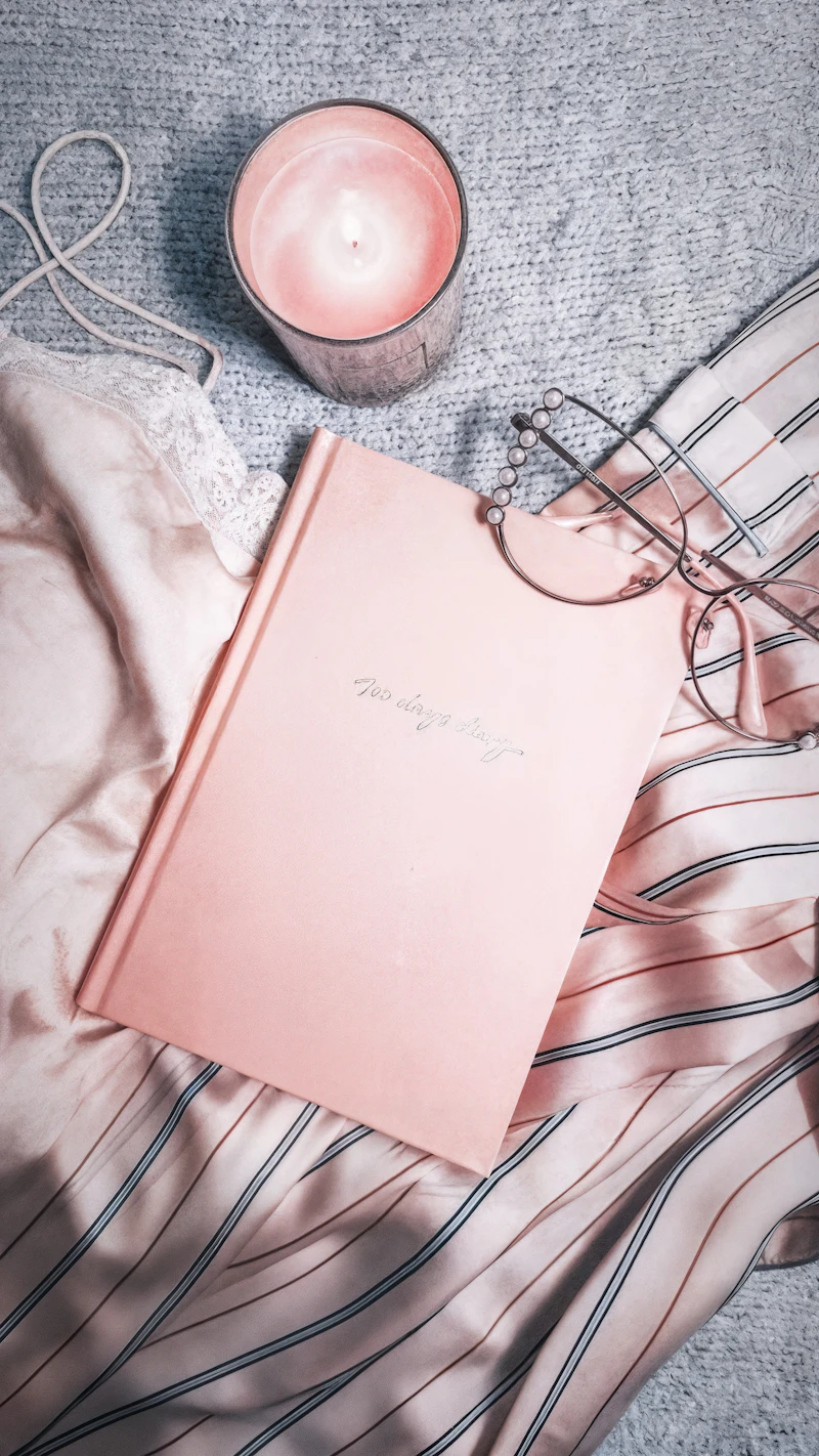 Cozy pink flatlay with a candle