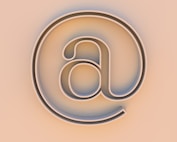 An "at" symbol on a beige background.