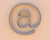 An "at" symbol on a beige background.