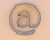 An "at" symbol on a beige background.