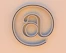 An "at" symbol on a beige background.