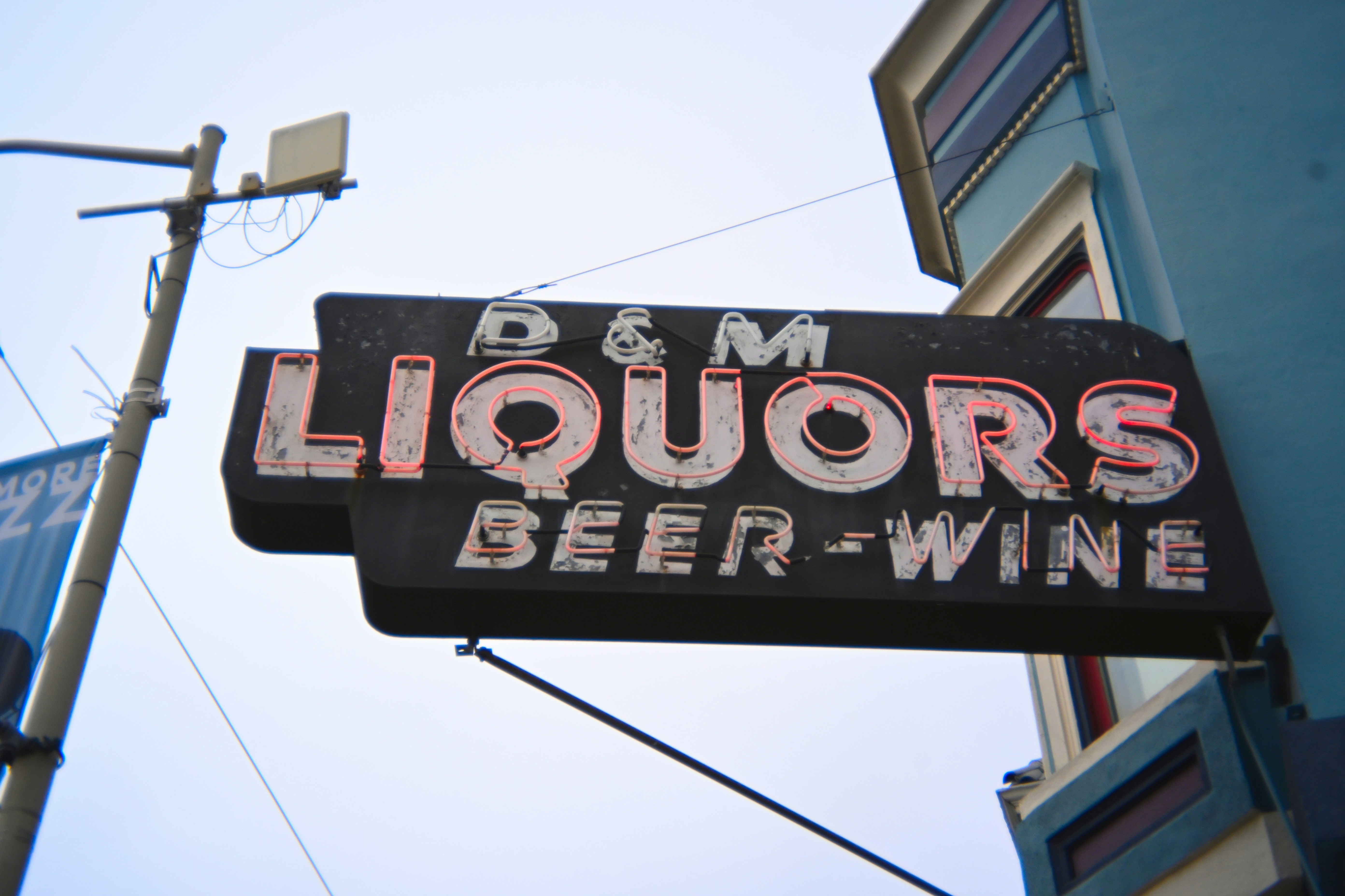A liquor store sign showing "d&m liquors".