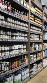 A grocery store shelf is full of preserved foods.