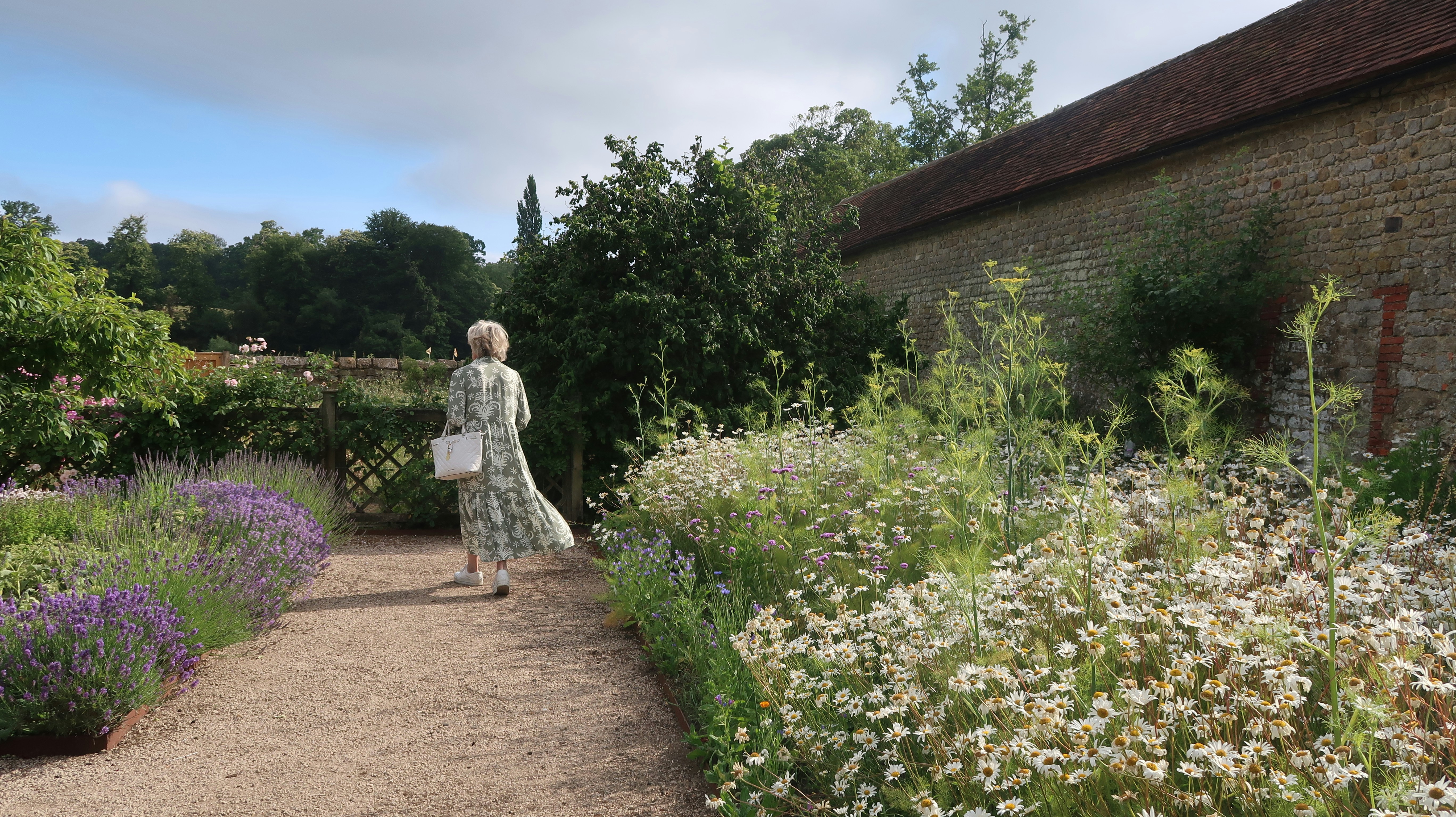 woman doing gentle walk in garden - week by week hysterectomy recovery