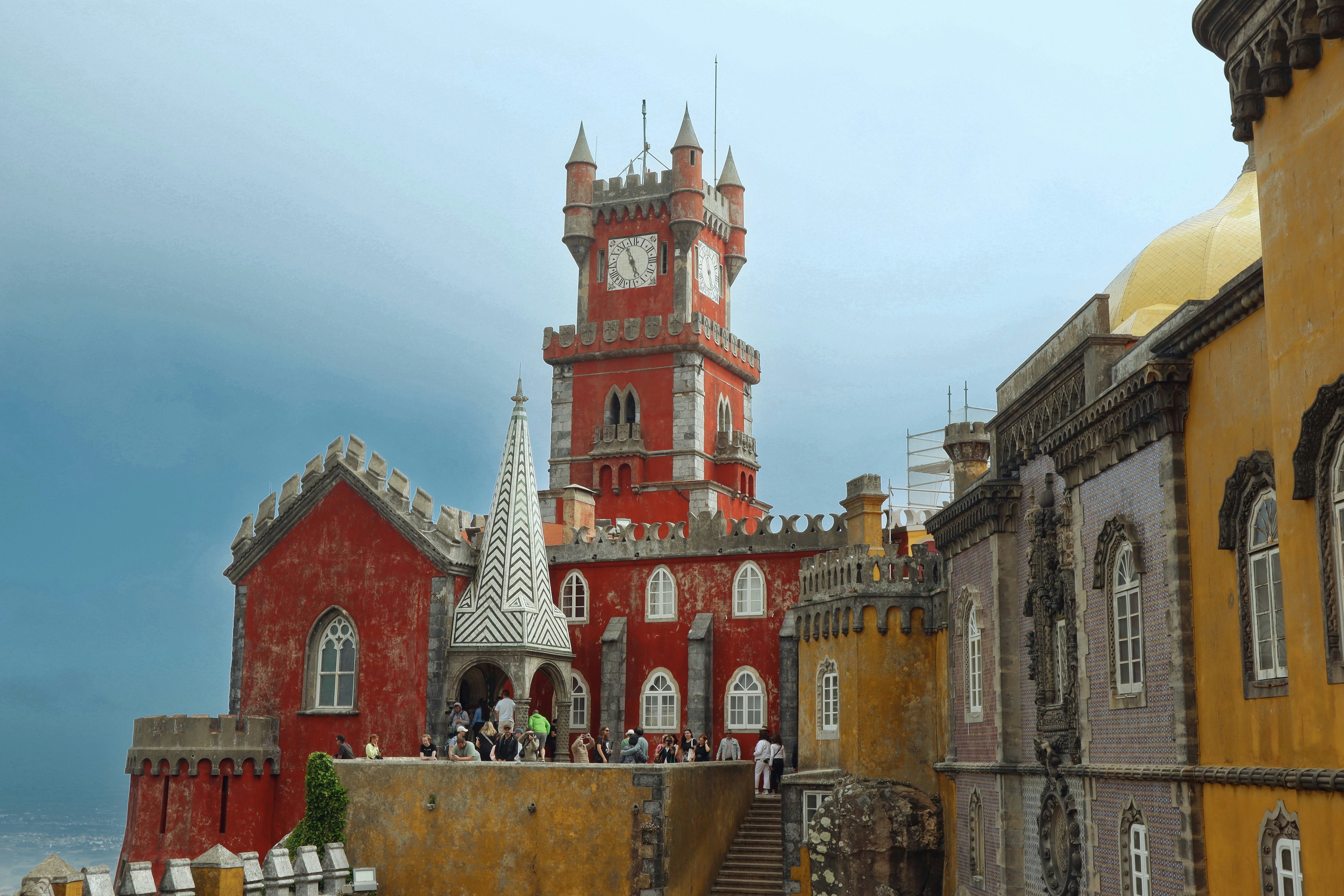 Colorful pena palace stands majestically against the cloudy sky.