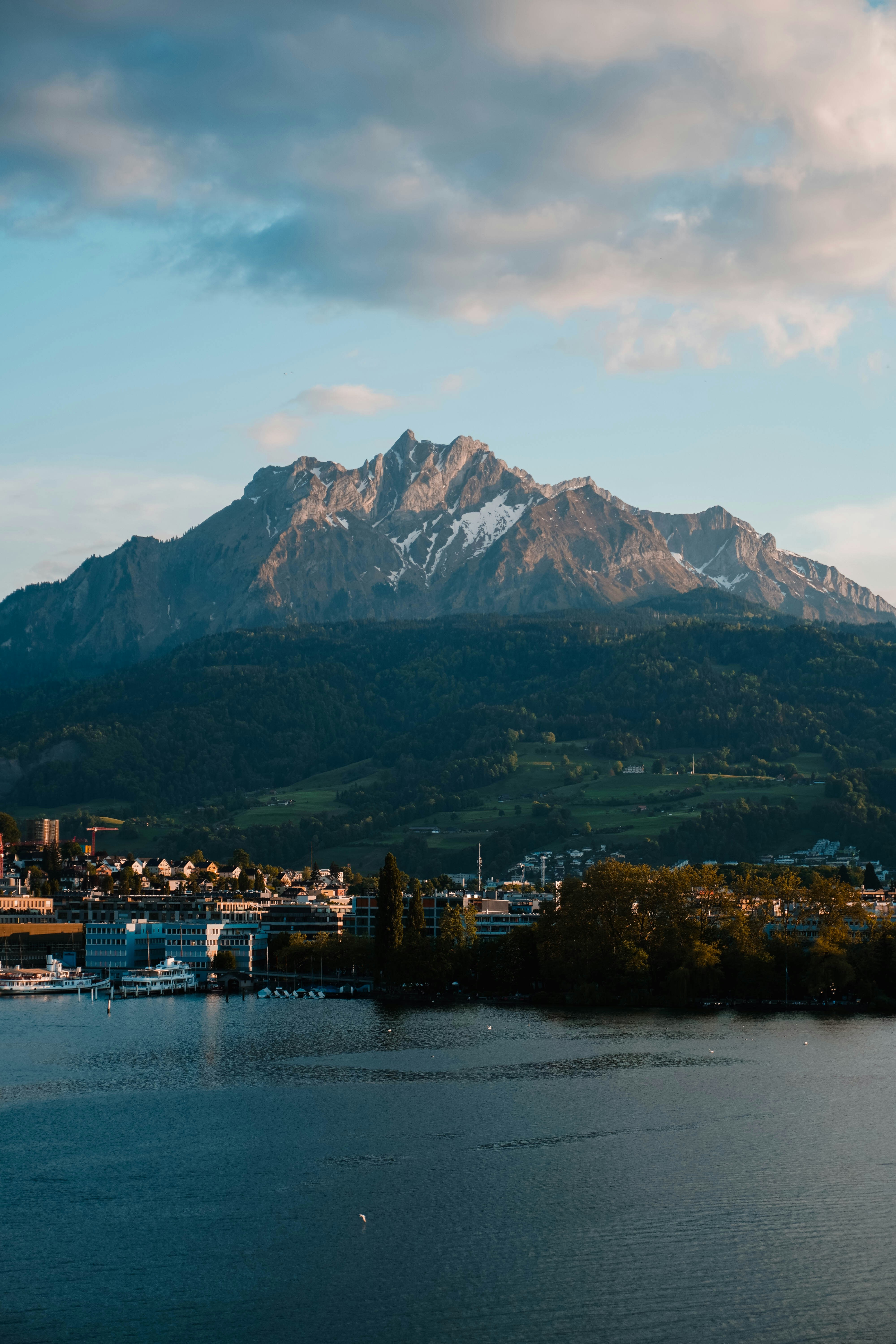 A mountain towers over the lake and city.