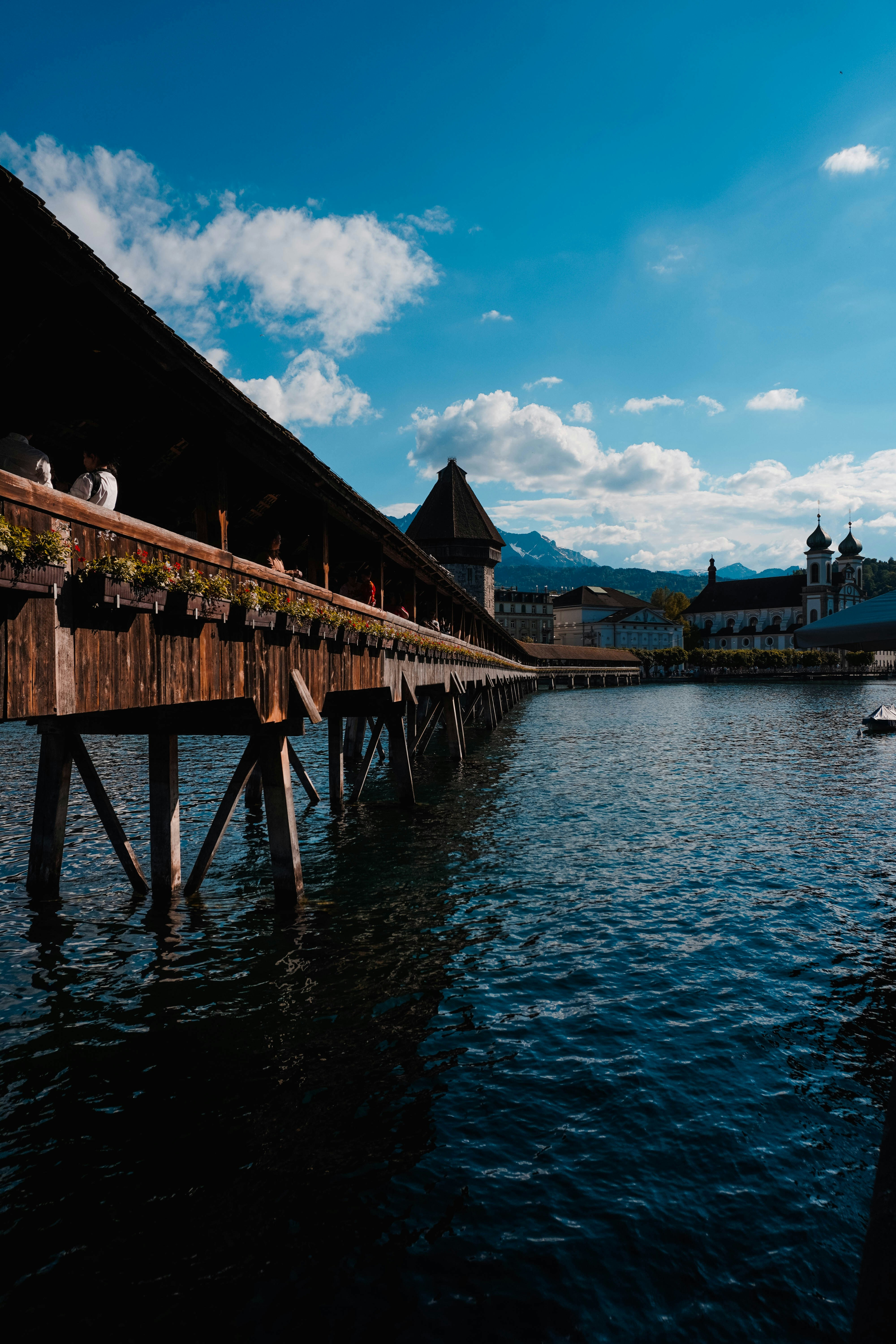 A covered wooden bridge spans the river.