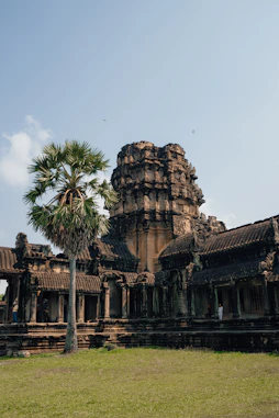 Ancient temple stands beneath a clear, blue sky.