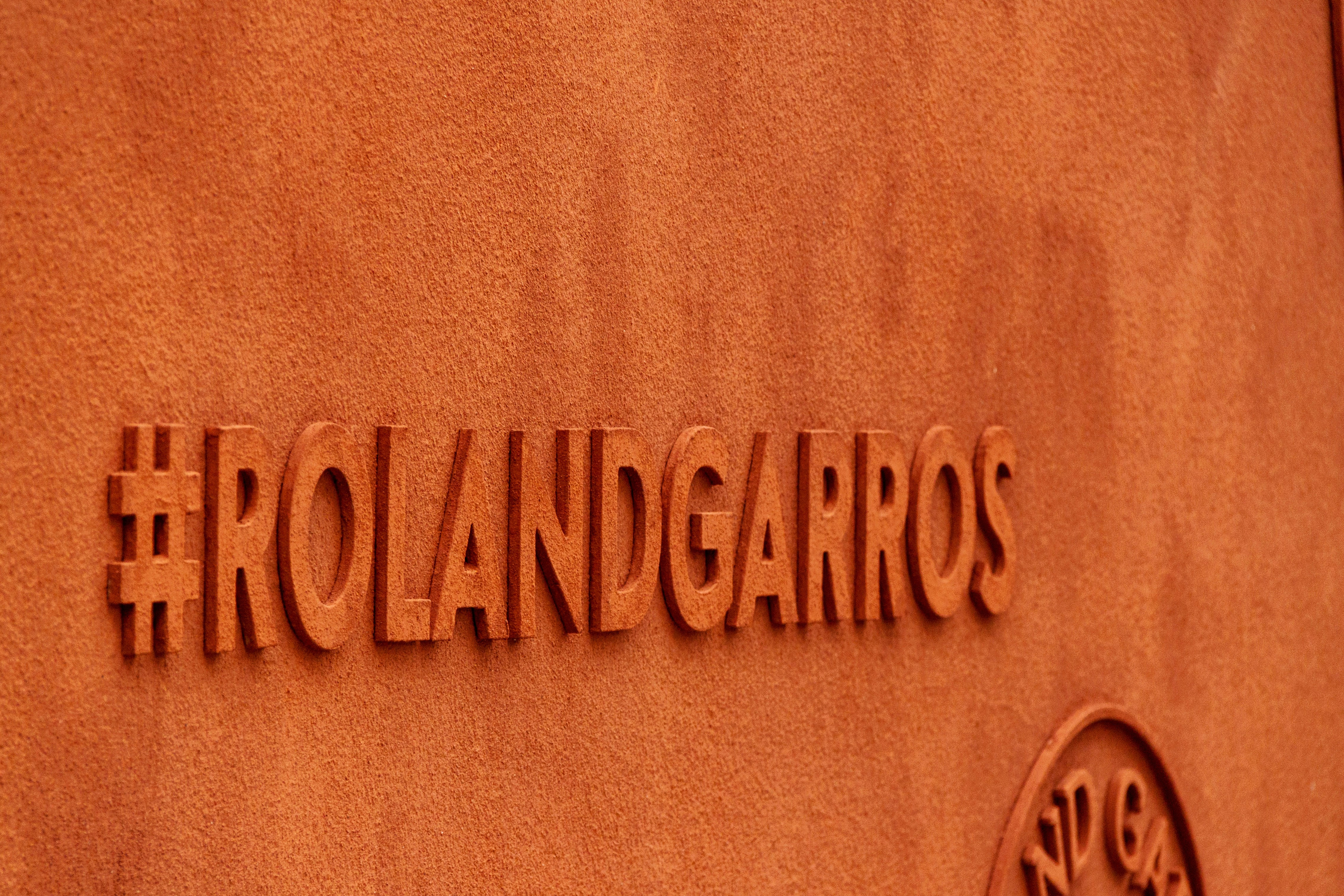 Hashtag #rolandgarros is embossed on the wall.