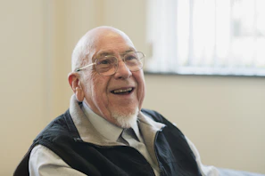Happy, older man smiles broadly at the camera
